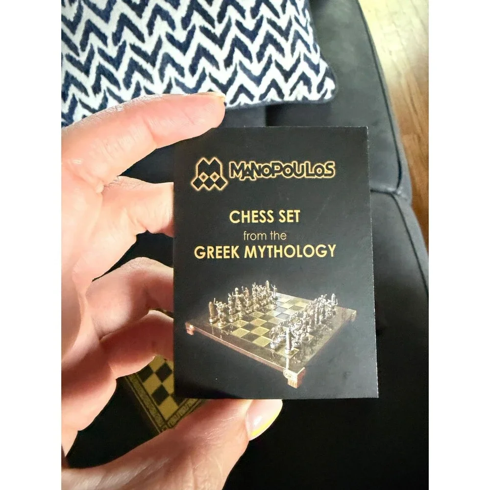 manopoulos chess set with Greek mythology pieces and guide.